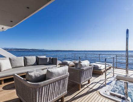 Sur le pont supérieur, on trouve un espace repas et un espace lounge, avec bains de soleil et canapés. Nautisme Article