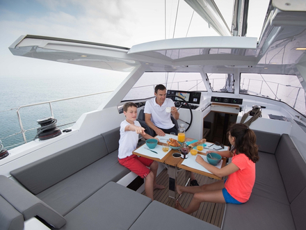 Confortablement installé sous la casquette de roof, qui intègre dorénavant une table pour huit personnes, vous découvrez sur la console les commandes qui permettent de dérouler les voiles sans quitter la barre. Nautisme Article