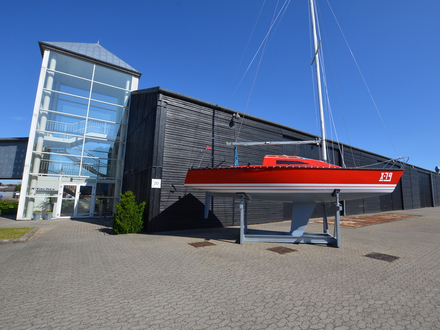 Un des premiers X 79, restauré par Birger Hansen, trône sur le parvis du chantier avec ses couleurs originales. Qui aurait prédit un tel succès ? Nautisme Article